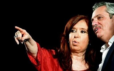 Argentina's former president and new vice president Cristina Fernandez waves at supporters next to president elect Alberto Fernandez, at the headquarters of the party in Buenos Aires on October 27, 2019. - Peronist candidate Alberto Fernandez won Argentina's presidential election in the first round on Sunday, official results showed, bringing to an end the crisis-plagued rule of market-friendly incumbent Mauricio Macri. (Photo by RONALDO SCHEMIDT / AFP)