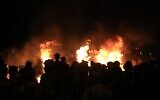 Burning tires light up the night skies during anti-government protests in the Shiite shrine city of Karbala, south of Iraq's capital Baghdad, late on October late October 28, 2019. (AFP)