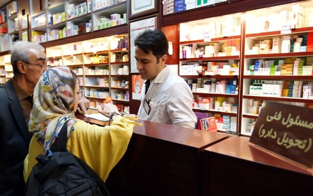 A file photo taken on September 11, 2018, shows an Iranian woman shopping at a pharmacy at the Nikan hospital in the Iranian capital Tehran. (STRINGER / AFP) A file photo taken on September 11, 2018, shows an Iranian woman shopping at a pharmacy at the Nikan hospital in the Iranian capital Tehran. (STRINGER / AFP)