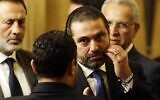 Lebanon's then Prime Minister Saad Hariri speaks to an unidentified man during a press conference at his residence in downtown Beirut, November 13, 2018. (Joseph Eid/AFP)