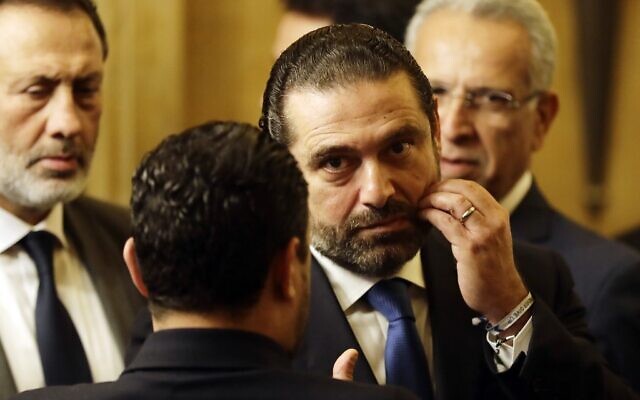 Lebanon's then Prime Minister Saad Hariri speaks to an unidentified man during a press conference at his residence in downtown Beirut, November 13, 2018. (Joseph Eid/AFP) Lebanon's then Prime Minister Saad Hariri speaks to an unidentified man during a press conference at his residence in downtown Beirut, November 13, 2018. (Joseph Eid/AFP)