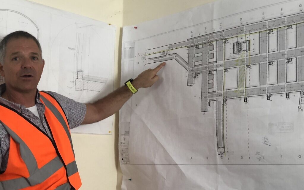 Adi Alphandary of Rolzur Tunneling points to architectural plans for the Jerusalem necropolis that will open soon. (Sam Sokol)