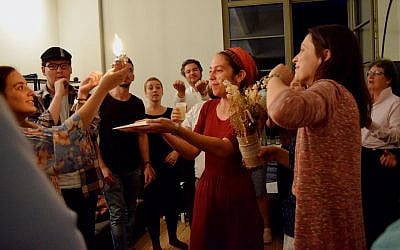 Illustrative: Rabbi Rebecca Blady, center, performs the havdallah ceremony in 2017. (Courtesy Base BERLIN)