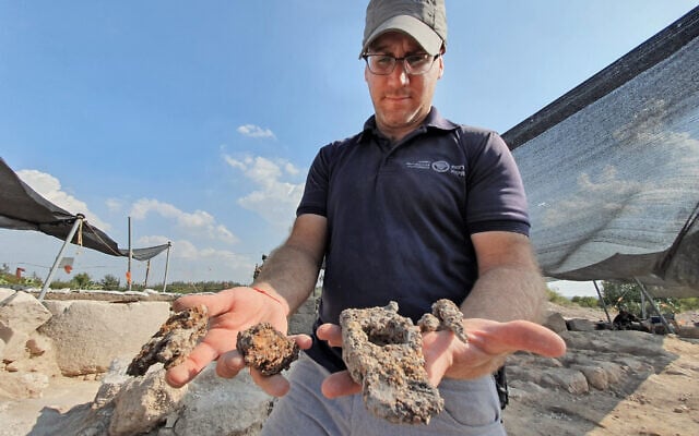 Yair Amitzur, director of the Usha excavation, with the 1,400 year-old iron hammer and nails, October 2019. (Yoli Schwartz, Israel Antiquities Authority) Yair Amitzur, director of the Usha excavation, with the 1,400 year-old iron hammer and nails, October 2019. (Yoli Schwartz, Israel Antiquities Authority)