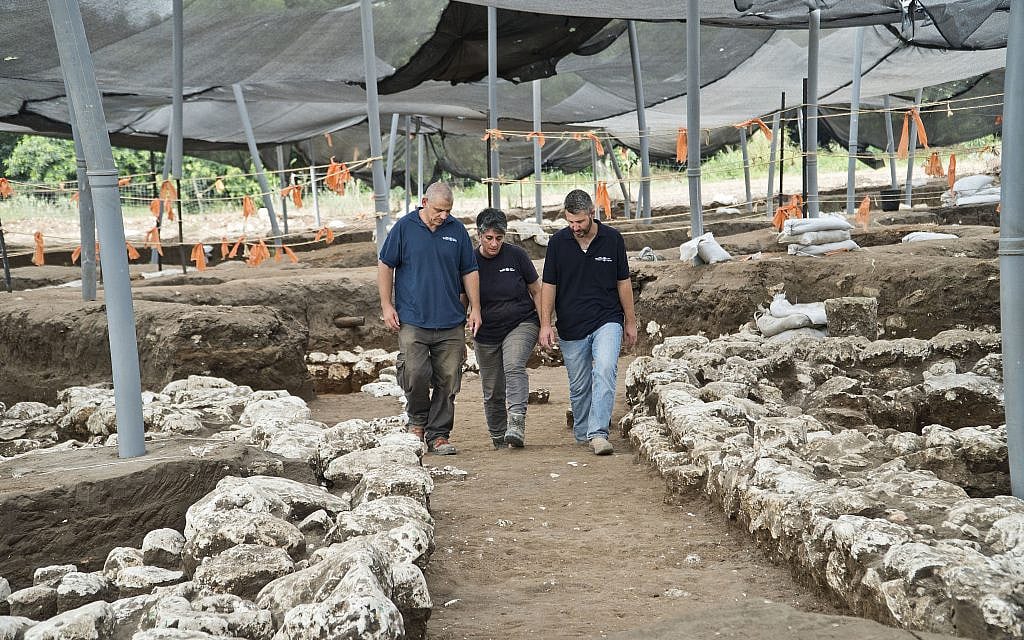 Excavation directors (left to right) Itai Elad, Dr. Dina Shalem, and Dr. Yitzhak Paz, walk in a 5,000-year-old alley at the Early Bronze Age excavation site near modern Harish. (Yoli Schwartz, Israel Antiquities Authority)