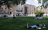 In this Wednesday, Sept. 25, 2019 photo people rest on grass while reading at Brown University, in Providence, Rhode Island (AP Photo/Steven Senne)