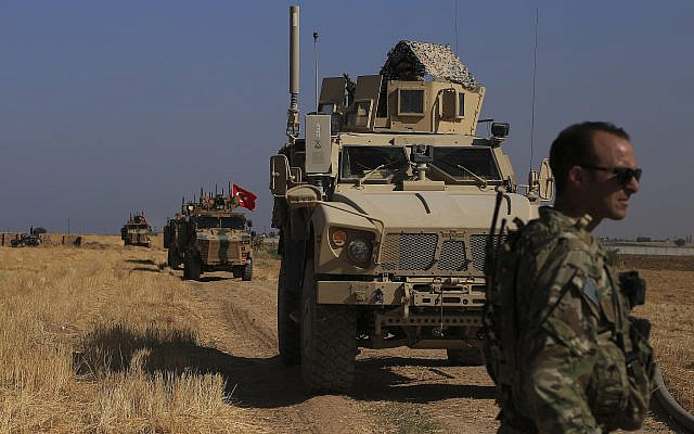 Turkish and American armored vehicles patrol in the so-called "safe zone" on the Syrian side of the border with Turkey, near the town of Tal Abyad, northeastern Syria, October 4, 2019. (AP Photo/Baderkhan Ahmad)