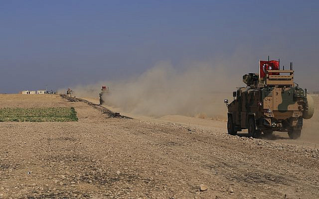 A Turkish armored vehicle patrols with American forces in the so-called "safe zone" on the Syrian side of the border with Turkey, near the town of Tal Abyad, northeastern Syria, October 4, 2019. (AP Photo/Baderkhan Ahmad)
