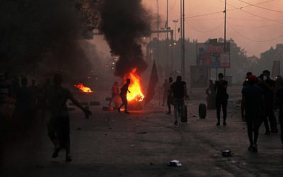 Anti-government protesters set fires and close a street during a demonstration in Baghdad, Iraq, October 5, 2019. (AP Photo/Hadi Mizban)