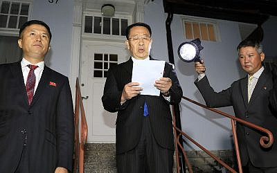 North Korean negotiator Kim Miyong Gil, center, reads statement outside the North Korean Embassy in Stockholm, Sweden, Oct. 5, 2019 (Kyodo News via AP)