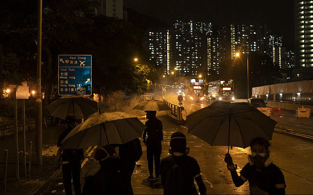 Protestors face police tear gas in Hong Kong, October 6, 2019. (AP Photo/Felipe Dana) Protestors face police tear gas in Hong Kong, October 6, 2019. (AP Photo/Felipe Dana)