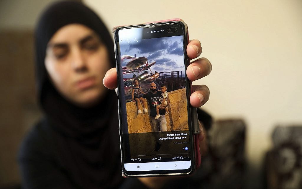 A relative on October 7, 2019, shows a photo of Ahmed Manaa with his children at the family home in Majd al-Krum, Israel. Two brothers, Ahmed and Khalil Manaa, and a third man, Mohammed Sabea, were killed in a midday shootout in Majd al-Krum, that left another Manaa brother wounded. (AP Photo/Mahmoud Illean) A relative on October 7, 2019, shows a photo of Ahmed Manaa with his children at the family home in Majd al-Krum, Israel. Two brothers, Ahmed and Khalil Manaa, and a third man, Mohammed Sabea, were killed in a midday shootout in Majd al-Krum, that left another Manaa brother wounded. (AP Photo/Mahmoud Illean)