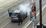 In this image taken from video made available by ATV-Studio Halle, a man shoots from a long-barreled gun, in Halle, Germany, October 9, 2019. (ATV-Studio via AP)