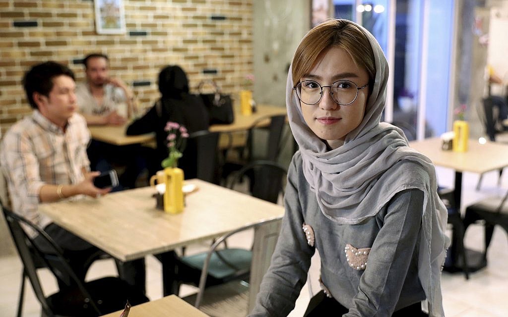In this October 7, 2019 photo, 21-year-old Afghan refugee Fatemeh Jafari poses for a photo at her basement Tehran coffee shop, in downtown Tehran, Iran. (AP Photo/Ebrahim Noroozi) In this October 7, 2019 photo, 21-year-old Afghan refugee Fatemeh Jafari poses for a photo at her basement Tehran coffee shop, in downtown Tehran, Iran. (AP Photo/Ebrahim Noroozi)