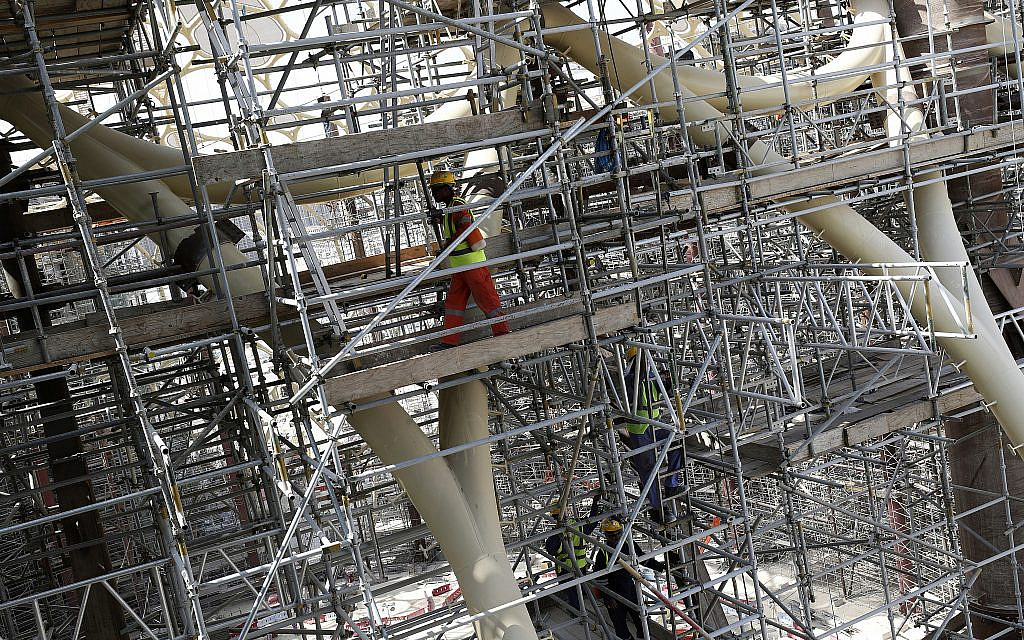 In this Oct. 8, 2019, photo, laborers work on the Al Wasl Dome at the under construction site of the Expo 2020 in Dubai, United Arab Emirates.  (AP Photo/Kamran Jebreili)