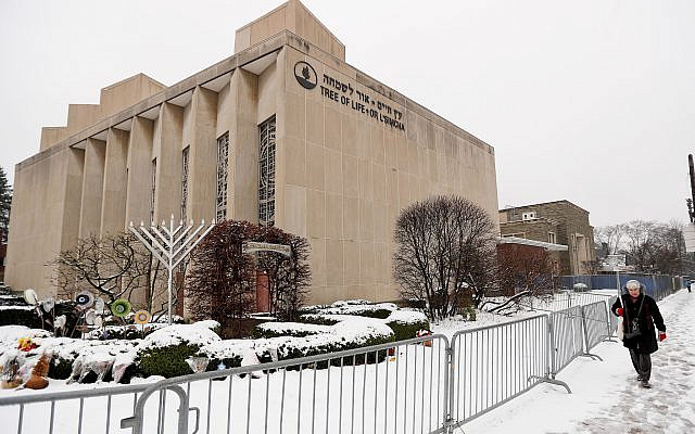 In this Monday, Feb. 11, 2019 file photo, a woman passes by the Tree of Life Synagogue in Pittsburgh's Squirrel Hill neighborhood. (AP Photo/Keith Srakocic) In this Monday, Feb. 11, 2019 file photo, a woman passes by the Tree of Life Synagogue in Pittsburgh's Squirrel Hill neighborhood. (AP Photo/Keith Srakocic)