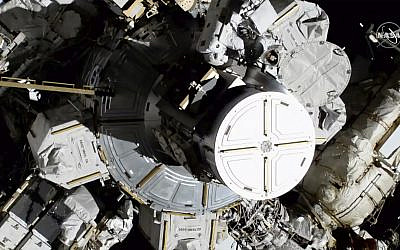 In this photo provided by NASA, astronauts Christina Koch and Jessica Meir exit the International Space Station on Friday, Oct. 18, 2019. (NASA via AP)