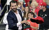 In this June 18, 2019, file photo, Donald Trump Jr. throws hats to supporters at a campaign rally for President Donald Trump in Orlando, Fla. (AP Photo/John Raoux)