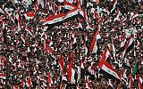 Followers of Shiite cleric Moqtada Al Sadr chant slogans against corruption, the US and Israel during demonstrations between the holy shrines of Imam Hussein and Imam Abbas on the Arbaeen Shiite festival in Karbala, Iraq, October 19, 2019. (AP Photo/Hadi Mizban)