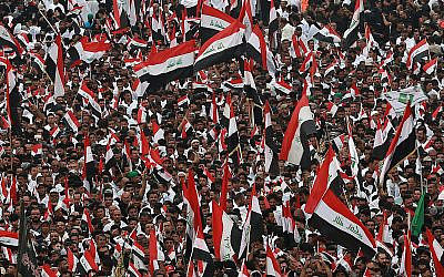 Followers of Shiite cleric Moqtada Al Sadr chant slogans against corruption, the US and Israel during demonstrations between the holy shrines of Imam Hussein and Imam Abbas on the Arbaeen Shiite festival in Karbala, Iraq, October 19, 2019. (AP Photo/Hadi Mizban)