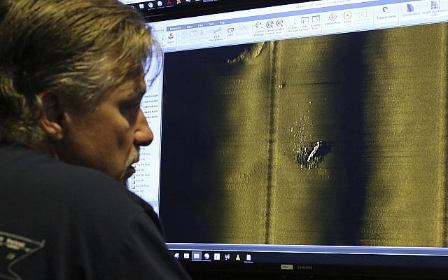 Rob Kraft, director of undersea operations at Vulcan Inc., reviews sonar scans of a warship from the World War II Battle of Midway that was found by the crew of the research vessel Petrel, Sunday, Oct. 20, 2019, off Midway Atoll in the Northwestern Hawaiian Islands. (AP Photo/Caleb Jones) Rob Kraft, director of undersea operations at Vulcan Inc., reviews sonar scans of a warship from the World War II Battle of Midway that was found by the crew of the research vessel Petrel, Sunday, Oct. 20, 2019, off Midway Atoll in the Northwestern Hawaiian Islands. (AP Photo/Caleb Jones)