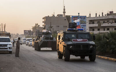 Russian forces patrol in the city of Amuda, north Syria, Thursday, Oct. 24, 2019. Syrian forces, Russian military advisers and military police are being deployed in a zone 30 kilometers (19 miles) deep along much of the northeastern border, under an agreement reached Tuesday by Russia and Turkey. (AP Photo/Baderkhan Ahmad)