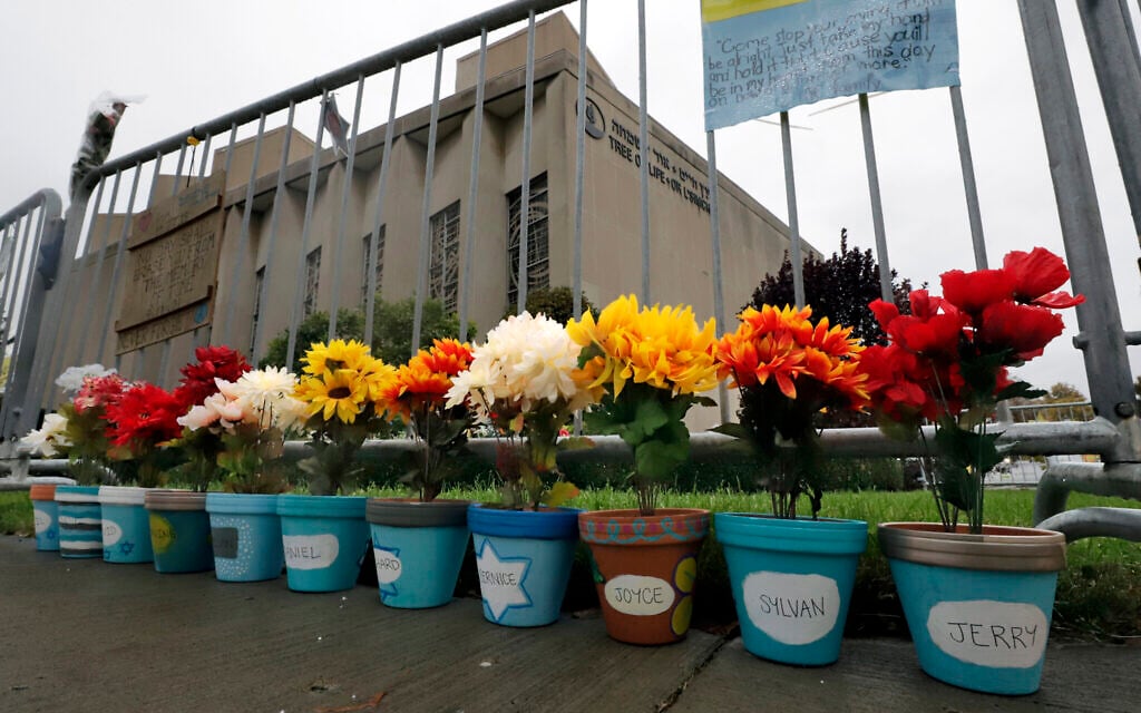 Flower pots, each with a name of one of the 11 worshipers killed on October 27, 2018, when a gunman opened fire as worship services began at the Tree of Life Synagogue, line the fence surrounding the synagogue on October 26, 2019, in the Squirrel Hill neighborhood of Pittsburgh, Pennsylvania. (AP Photo/Gene J. Puskar)