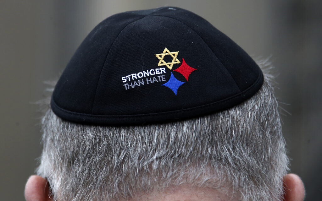 A man wearing a Stronger Than Hate Yamulke stands outside the Tree of Life synagogue in Pittsburgh on Sunday, Oct. 27, 2019, the first anniversary of the shooting at the synagogue, that killed 11 worshippers.(AP Photo/Gene J. Puskar)