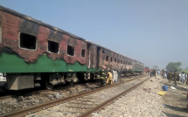 Pakistani officials examine a train damaged by a fire in Liaquatpur, Pakistan, October 31, 2019. (Siddique Baluch/AP) Pakistani officials examine a train damaged by a fire in Liaquatpur, Pakistan, October 31, 2019. (Siddique Baluch/AP)