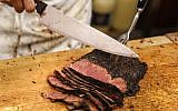 A man carves pastrami at Katz's Delicatessen in New York, Thursday, May 11, 2017. (AP/Seth Wenig)