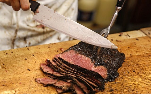 A man carves pastrami at Katz's Delicatessen in New York, Thursday, May 11, 2017. (AP/Seth Wenig)