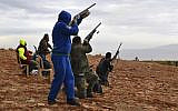 This Oct. 28, 2017 photo, shows hunters shooting at birds near the town of Brital, Bekaa Valley, Lebanon. Lebanon lies on key migratory routes for several protected European species of birds that winter in the Persian Gulf and Africa.  (AP Photo/Philip Issa)
