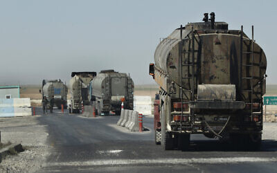 File: In this April 4, 2018 photo, a convoy of oil trucks passes a Kurdish police checkpoint as they move fuel produced in Kurdish-held areas in Syris (AP Photo/Hussein Malla)