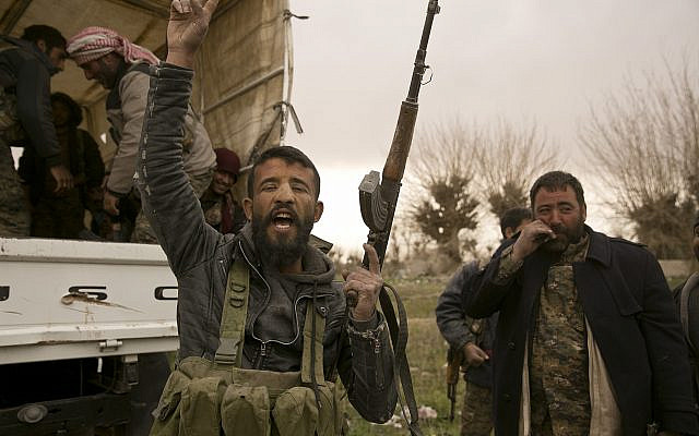 A US-backed Syrian Democratic Forces (SDF) fighter chants slogans before heading to the front line to fight Islamic State militants in their last stronghold of Baghouz, Syria, March 14, 2019. (AP Photo/Maya Alleruzzo)