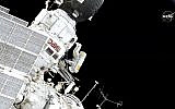 In this image made from video provided by NASA, Expedition 59 Commander Oleg Kononenko, center, participates in a spacewalk outside the International Space Station with Flight Engineer Alexey Ovchinin, obscured, on Wednesday, May 29, 2019. (NASA via AP)