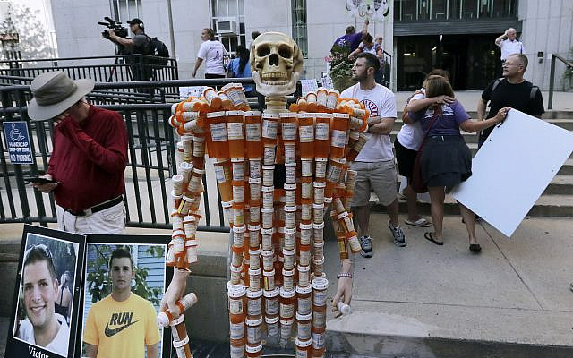 ILLUSTRATIVE -- A skeleton of pill bottles stands with protesters outside a courthouse on Aug. 2, 2019, in Boston where a judge was to hear arguments in Massachusetts' lawsuit against Purdue Pharma over its role in the national drug epidemic (AP Photo/Charles Krupa) ILLUSTRATIVE -- A skeleton of pill bottles stands with protesters outside a courthouse on Aug. 2, 2019, in Boston where a judge was to hear arguments in Massachusetts' lawsuit against Purdue Pharma over its role in the national drug epidemic (AP Photo/Charles Krupa)