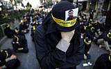 Illustrative: A Shiite supporter of the Iranian-backed Hezbollah terror group with a portrait of a dead Hezbollah fighter on his head weeps as he listens to the death story of Imam Hussein during the holy day of Ashoura, in the southern suburbs of Beirut, Lebanon, on September 10, 2019. (AP Photo/Hussein Malla)