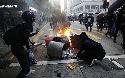 Anti-government protesters set fire to block traffic in Hong Kong, October 1, 2019. (AP Photo/Gemunu Amarasinghe )