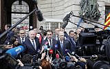 French Interior Minister Christophe Castaner, center, and Paris police prefect Didier Lallement, right next to Castaner, give a press conference outside the Paris police headquarters, October 3, 2019 in Paris. (AP Photo/Kamil Zihnioglu)