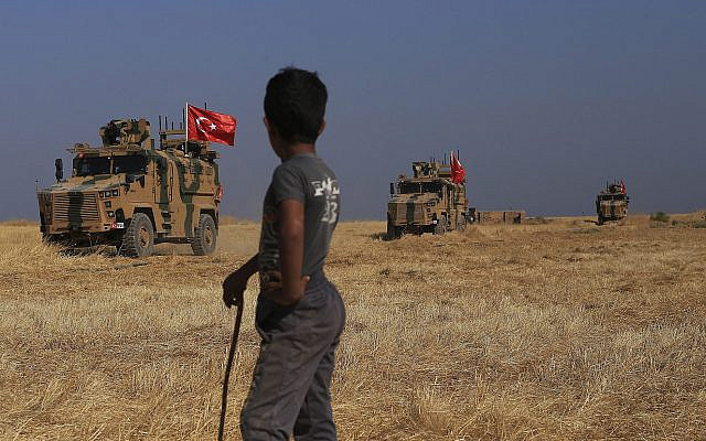 Turkish armored vehicles patrol as they conduct a joint ground patrol with American forces in the so-called "safe zone" on the Syrian side of the border with Turkey, near the town of Tal Abyad, northeastern Syria, October 4, 2019. (AP Photo/Baderkhan Ahmad) Turkish armored vehicles patrol as they conduct a joint ground patrol with American forces in the so-called "safe zone" on the Syrian side of the border with Turkey, near the town of Tal Abyad, northeastern Syria, October 4, 2019. (AP Photo/Baderkhan Ahmad)