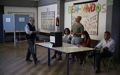 A voter casts his ballot at a polling station in Lisbon, Oct. 6, 2019. (AP Photo/Armando Franca)
