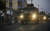 Shortly after the Turkish operation inside Syria had started, local residents cheer and applaud as a convoy of Turkish forces vehicles is driven through the town of Akcakale, Sanliurfa province, southeastern Turkey, at the border between Turkey and Syria, Oct. 9, 2019 (AP Photo/Lefteris Pitarakis)