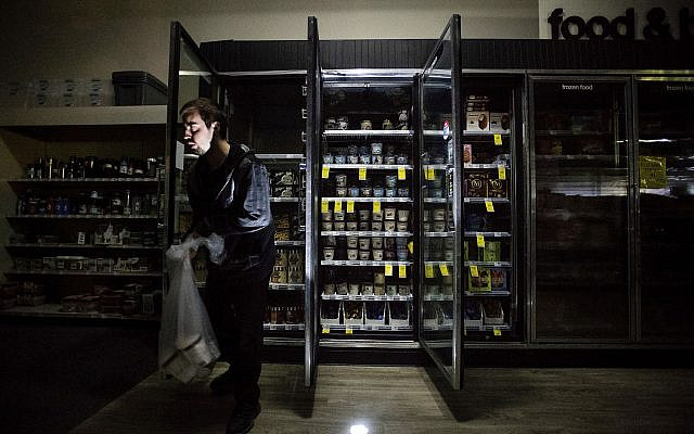 CVS Pharmacy shift supervisor James Quinn throws out ice cream from darkened freezers as downtown Sonoma, California, remains without power on Oct. 9, 2019 (AP Photo/Noah Berger) CVS Pharmacy shift supervisor James Quinn throws out ice cream from darkened freezers as downtown Sonoma, California, remains without power on Oct. 9, 2019 (AP Photo/Noah Berger)
