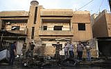 People gather after a car bomb exploded in the town of Qamishli, Syria, Friday, October 11, 2019. (AP/Baderkhan Ahmad)