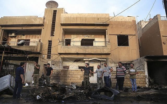 People gather after a car bomb exploded in the town of Qamishli, Syria, Friday, October 11, 2019. (AP/Baderkhan Ahmad) People gather after a car bomb exploded in the town of Qamishli, Syria, Friday, October 11, 2019. (AP/Baderkhan Ahmad)