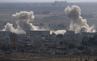 Smoke and dust billows from targets in Ras al-Ayn, Syria, caused by bombardment by Turkish forces, October 15, 2019. (Lefteris Pitarakis/AP)