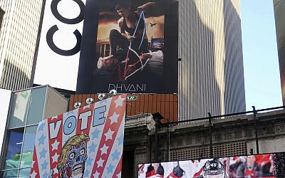 A billboard in New York City's Time Square depicts US President Donald Trump being hogtied by a woman clad in athletic wear on Oct. 18, 2019  (AP Photo/Ted Shaffrey)