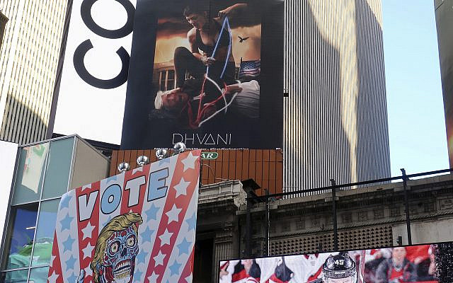 A billboard in New York City's Time Square depicts US President Donald Trump being hogtied by a woman clad in athletic wear on Oct. 18, 2019 (AP Photo/Ted Shaffrey) A billboard in New York City's Time Square depicts US President Donald Trump being hogtied by a woman clad in athletic wear on Oct. 18, 2019 (AP Photo/Ted Shaffrey)