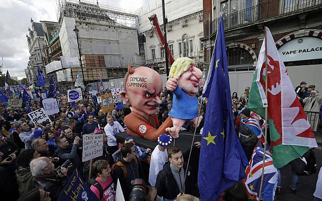 An effigy of Dominic Cummings, left, top advisor to British Prime Minister Boris Johnson, holds an effigy of Prime Minister Johnson, right, during a protest march in London, Oct. 19, 2019 (AP Photo/Matt Dunham) An effigy of Dominic Cummings, left, top advisor to British Prime Minister Boris Johnson, holds an effigy of Prime Minister Johnson, right, during a protest march in London, Oct. 19, 2019 (AP Photo/Matt Dunham)