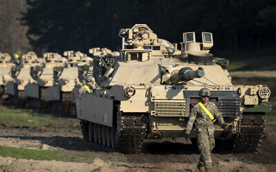 Illustrative: A member of the US Army's 1st Armored Battalion of the 9th Regiment, 1st Division from Fort Hood in Texas walks near Abrams battle tanks after arriving at the Pabrade railway station some 50 km (31 miles) north of the capital Vilnius, Lithuania, Monday, Oct. 21, 2019. (AP Photo/Mindaugas Kulbis)